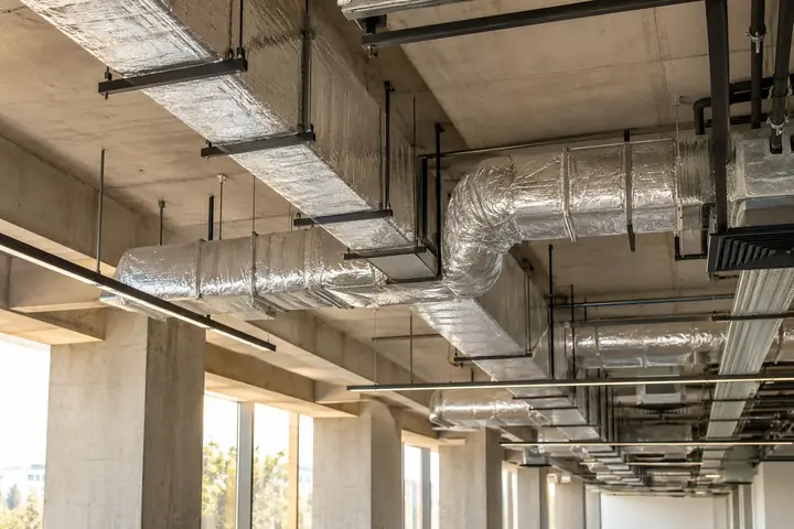 Neatly insulated ventilation ducts and support hangers in a modern building
